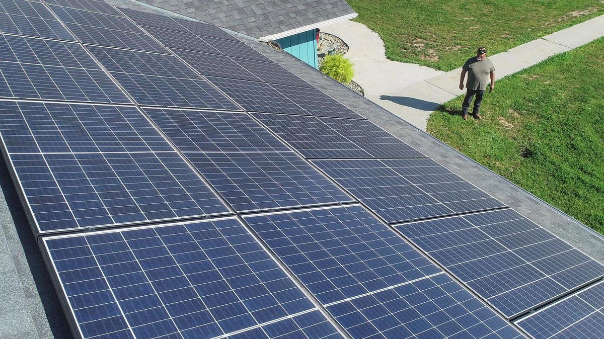 Ramon Torres, who lives in the Madera Ranchos area of Madera County, looks up at the solar panels covering the top of his roof on Friday, March 27, 2021. A state proposal would dramatically reduce bill credits paid out by PG&E and other utilities for excess power fed back to the grid. Torres believes this is unfair since those credits helped him finance his solar panels.