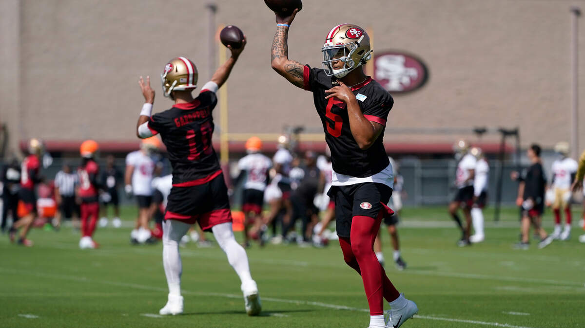 San Francisco 49ers quarterbacks Trey Lance and Jimmy Garoppolo throw during training camp in Santa Clara on Wednesday, July 28, 2021.
