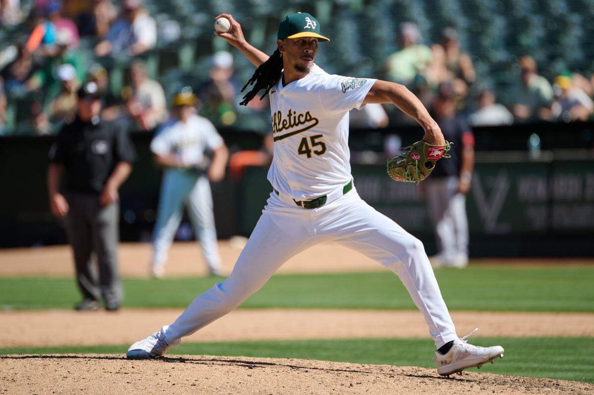 Sep 7, 2024; Oakland, California, USA; Oakland Athletics pitcher Osvaldo Bido (45) throws a pitch against the Detroit Tigers during the eighth inning at Oakland-Alameda County Coliseum. Mandatory Credit: Robert Edwards-Imagn Images