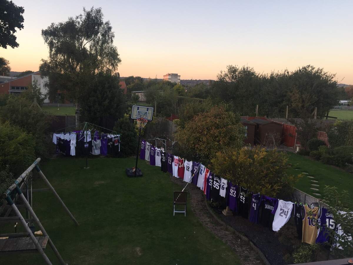 A sampling of Danny Williamson’s numerous Kings jerseys and shirts are seen hanging up in a yard.