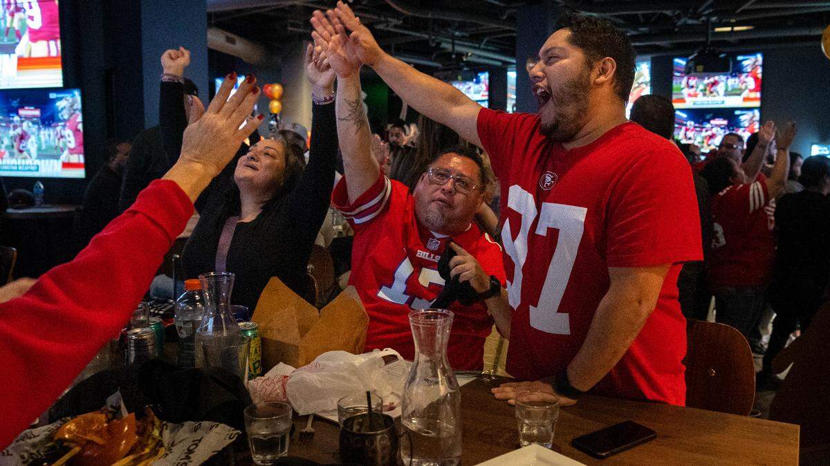 Demetrias Perdomo of Vacaville, Calif. right, celebrates a 49ers touchdown during the NFC Championship game watch party at Tom’s Watch Bar on Sunday, Jan. 28, 2024.