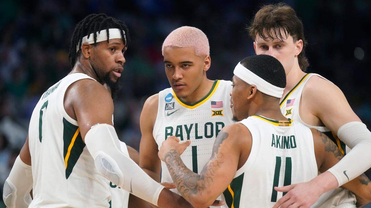 Baylor players Flo Thamba (0), Jeremy Sochan (1), James Akinjo (11) and Matthew Mayer (24) hug during the second half of a college basketball game against Norfolk State in the first round of the NCAA tournament in Fort Worth, Texas, Thursday, March 17, 2022. (AP Photo/LM Otero)