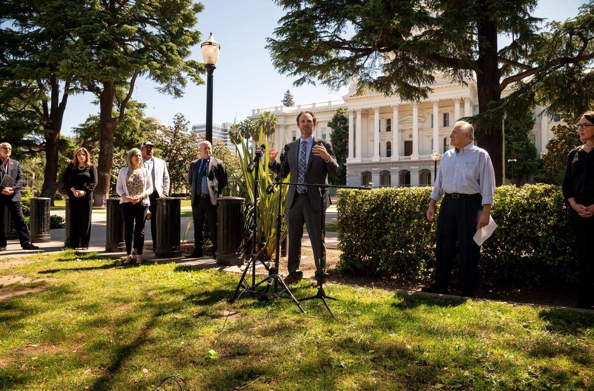 Assemblyman James Gallagher, R-Yuba City, center, speaks to news media at the Capitol on Tuesday, April 28, 2020, about a letter he signed along with state Sen. Jim Nielsen, R-Red Bluff, and 20 local leaders and representatives of mostly rural areas in Northern California, asking Gov. Gavin Newsom to begin lifting shelter-in-place orders based on regional coronavirus infection numbers.