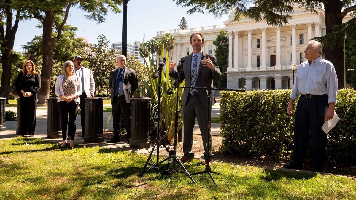 Assemblyman James Gallagher, R-Yuba City, center, speaks to news media at the Capitol on Tuesday, April 28, 2020, about a letter he signed along with state Sen. Jim Nielsen, R-Red Bluff, and 20 local leaders and representatives of mostly rural areas in Northern California, asking Gov. Gavin Newsom to begin lifting shelter-in-place orders based on regional coronavirus infection numbers.