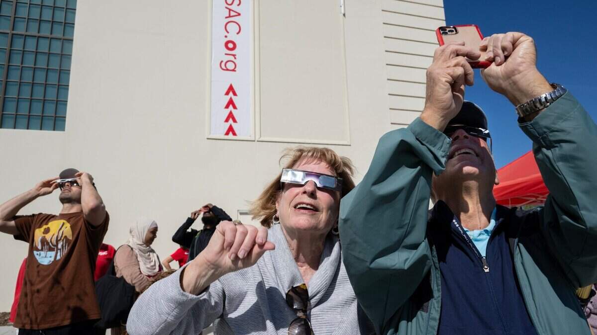 Cathy and Bill Maffei of Carmichael wear solar eclipse glasses as they view their first solar eclipse on Monday, April 8, 2024, at the Museum of Science and Curiosity in Sacramento.