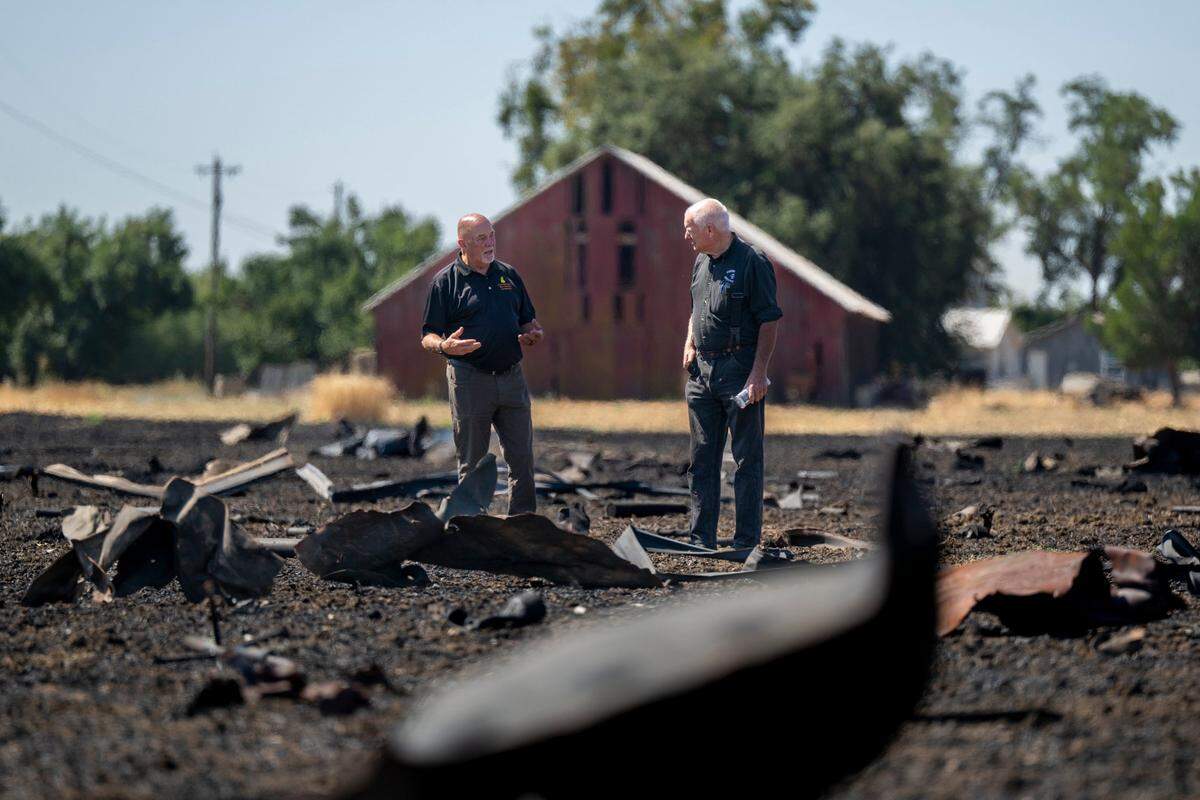 Fire investigators examine debris from the Devastating Pyrotechnics explosion in a nearby field in Esparto on Monday. The facility exploded on July 1.