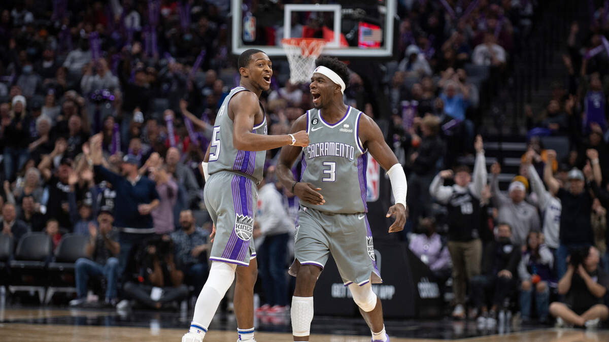 Sacramento Kings guard De’Aaron Fox (5) and teammate guard Terence Davis (3) celebrate following a made basket in the second half of an NBA basketball game against the Brooklyn Nets in Sacramento, Calif., Tuesday, Nov. 15, 2022. The Kings won 153-121. (AP Photo/José Luis Villegas)