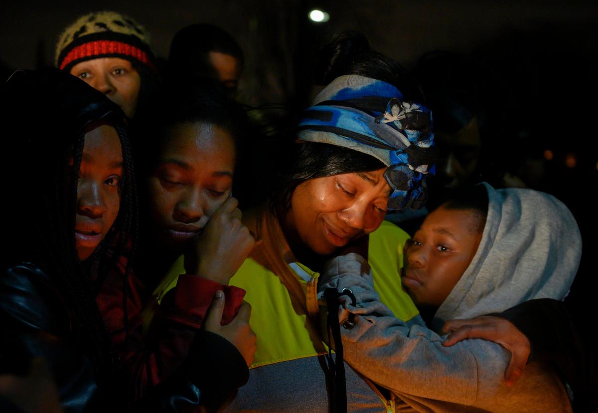 Family and friends comfort Ebony Douglas at a Wednesday night vigil for her daughter, Dajha Richards.