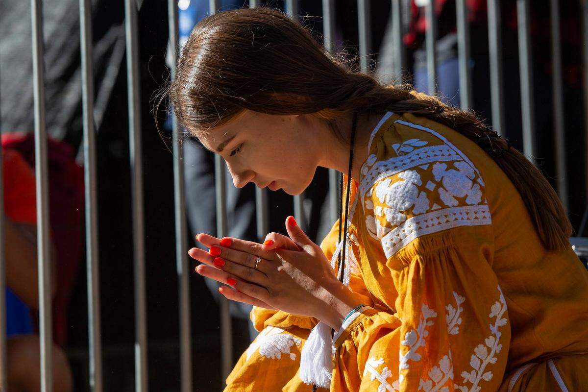 Novikova Sofia prays before her brother Oleksii Novikov, of Ukraine, before he competes in the bus pull event during 2022 Worlds Strongest Man competition at Capitol Mall on Sunday, May 29, 2022, in downtown Sacramento. Novikov finished first place out of ten athletes with a time of 0:41.51 seconds. Novikov was the 2020 Strongest Man winner for the first time in his career.