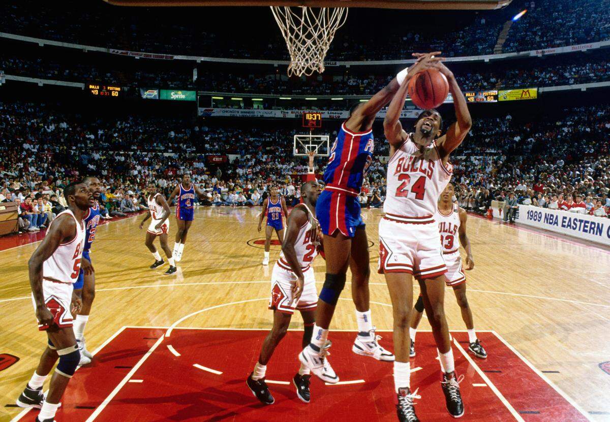 Chicago Bulls center Bill Cartwright (24) grabs a rebound in front of Detroit Pistons forward John Salley (22) during the 1988-89 NBA Eastern Conference Finals at Chicago Stadium.