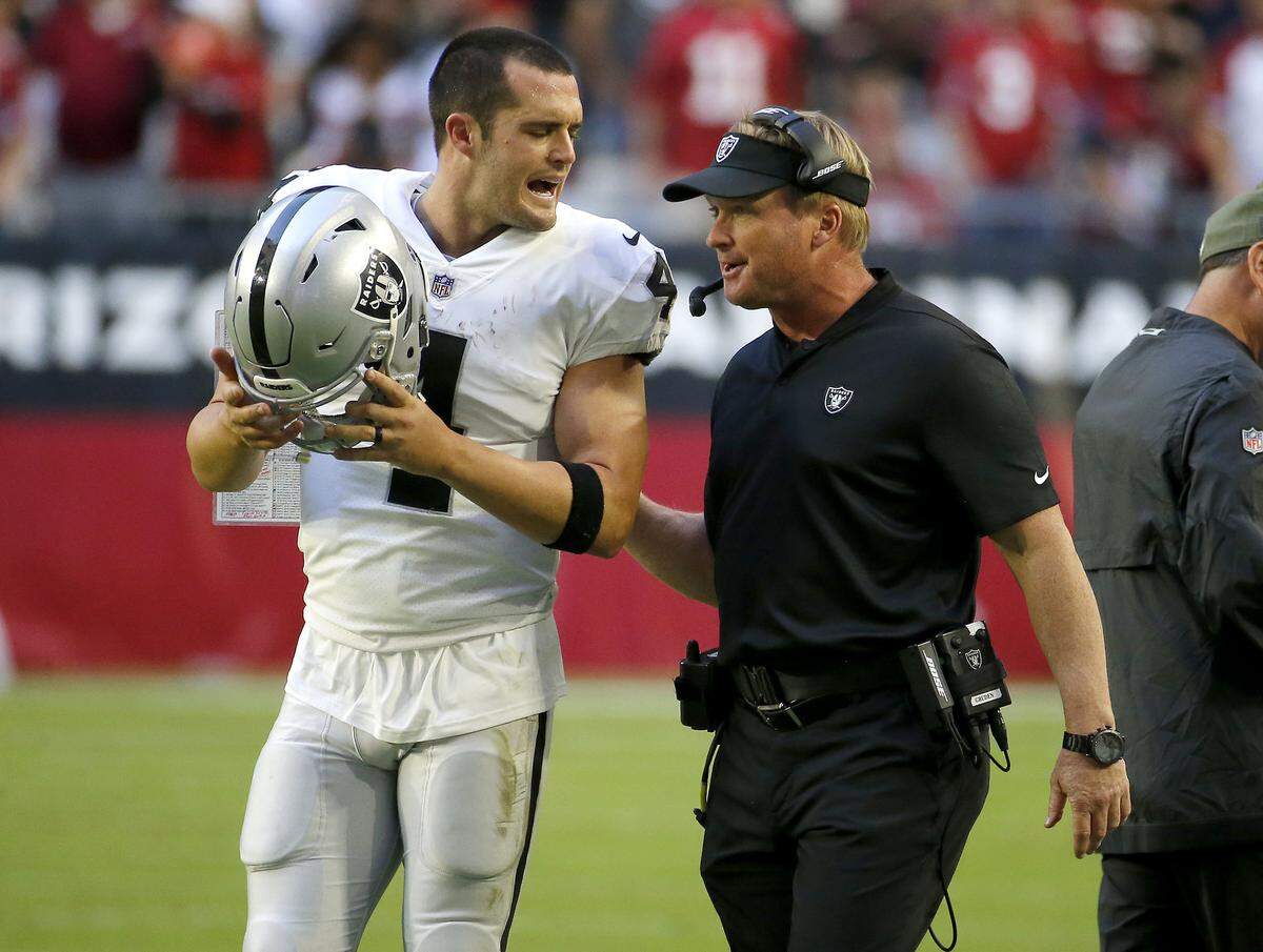 Oakland Raiders quarterback Derek Carr (4) talks with head coach Jon Gruden during the second half of an NFL football game against the Arizona Cardinals , Sunday, Nov. 18, 2018, in Glendale, Ariz.