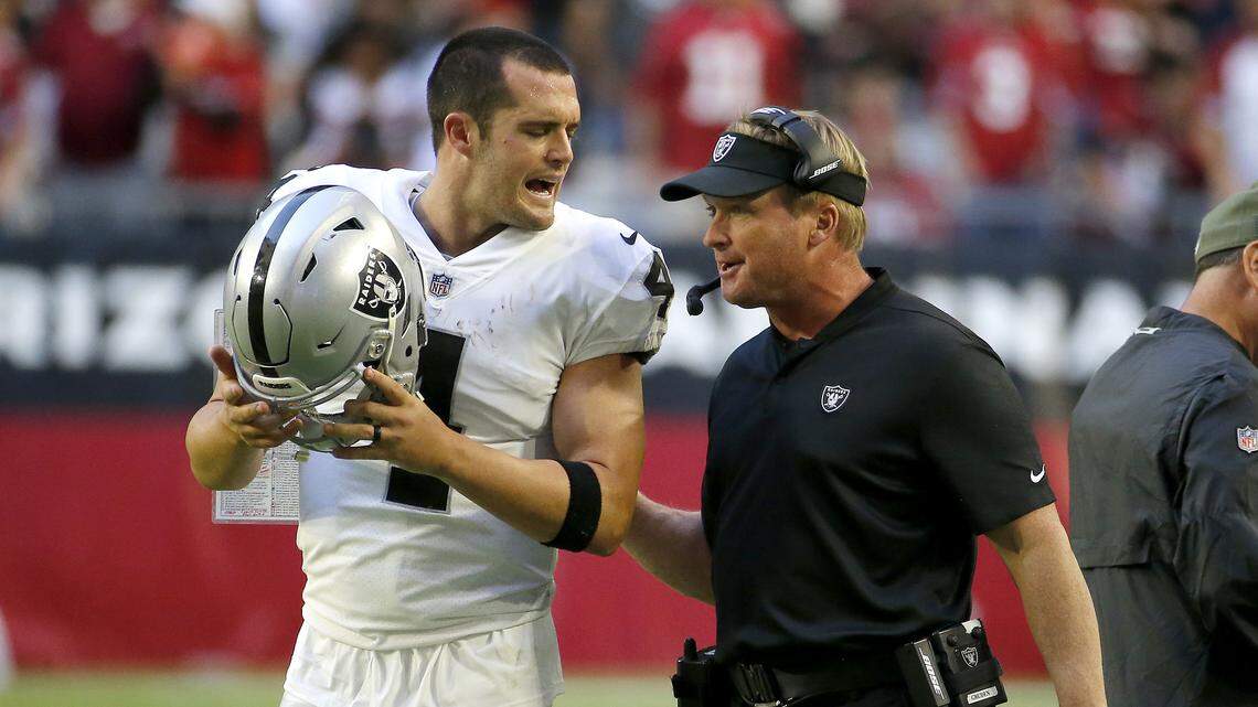 Oakland Raiders quarterback Derek Carr (4) talks with head coach Jon Gruden during the second half of an NFL football game against the Arizona Cardinals , Sunday, Nov. 18, 2018, in Glendale, Ariz. (AP Photo/Rick Scuteri)