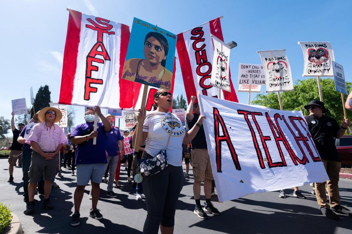 The Sacramento City Teachers Association and SEIU Local 1021 demonstrate outside of the Sacramento County Office of Education in Rancho Cordova on Thursday, the second day of the teachers strike over an impasse in bargaining over the district’s plans for COVID-19 spending and health protocols.