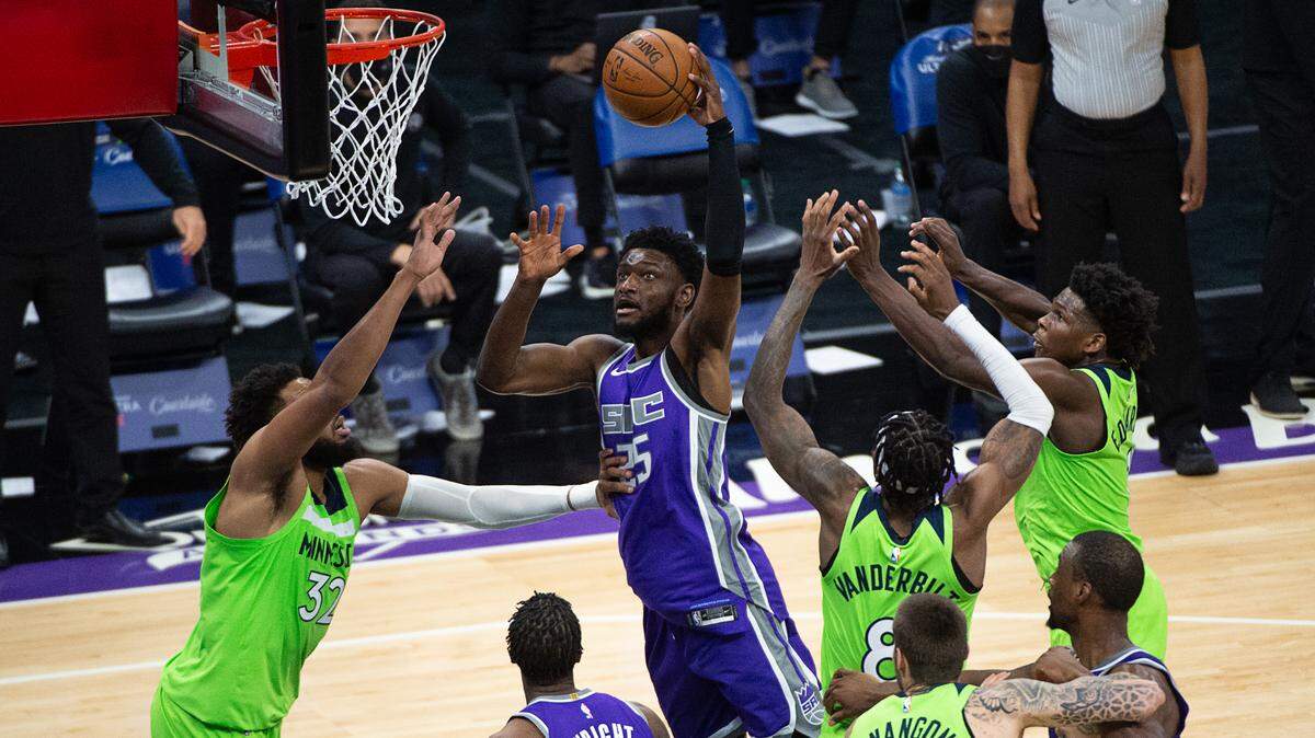 Sacramento Kings forward Chimezie Metu (25) drives to basket defended by Minnesota Timberwolves center Karl-Anthony Towns (32) in the third quarter during a game at Golden 1 Center on Tuesday, April 20, 2021 in Sacramento. Metu came off the bench to score a career-high 16 points.