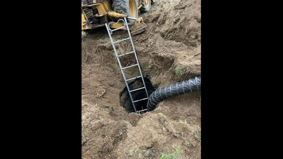 Firefighters worked to rescue the man who had fallen into the septic tank.