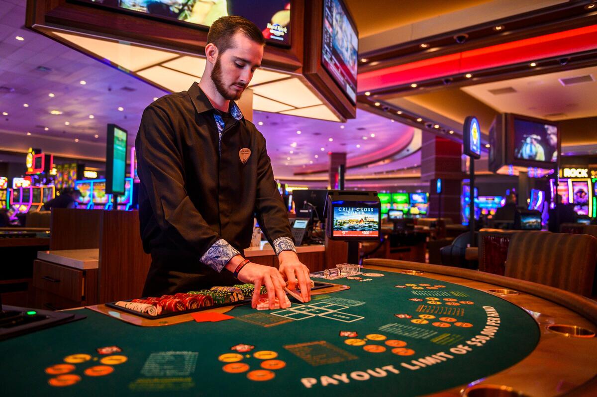 Criss Cross poker dealer Ben Mayer shuffles cards as he waits for customers at the Hard Rock Casino Sacramento in south Yuba County on Feb. 25.