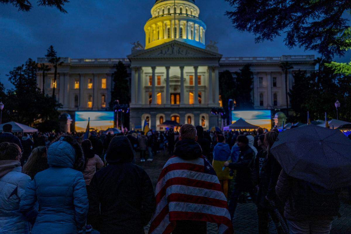 The dome of the California Capitol is lit with yellow and blue light on Friday in solidarity with the Ukrainian people during a rally to mark the one-year anniversary of the Russian invasion of the country.