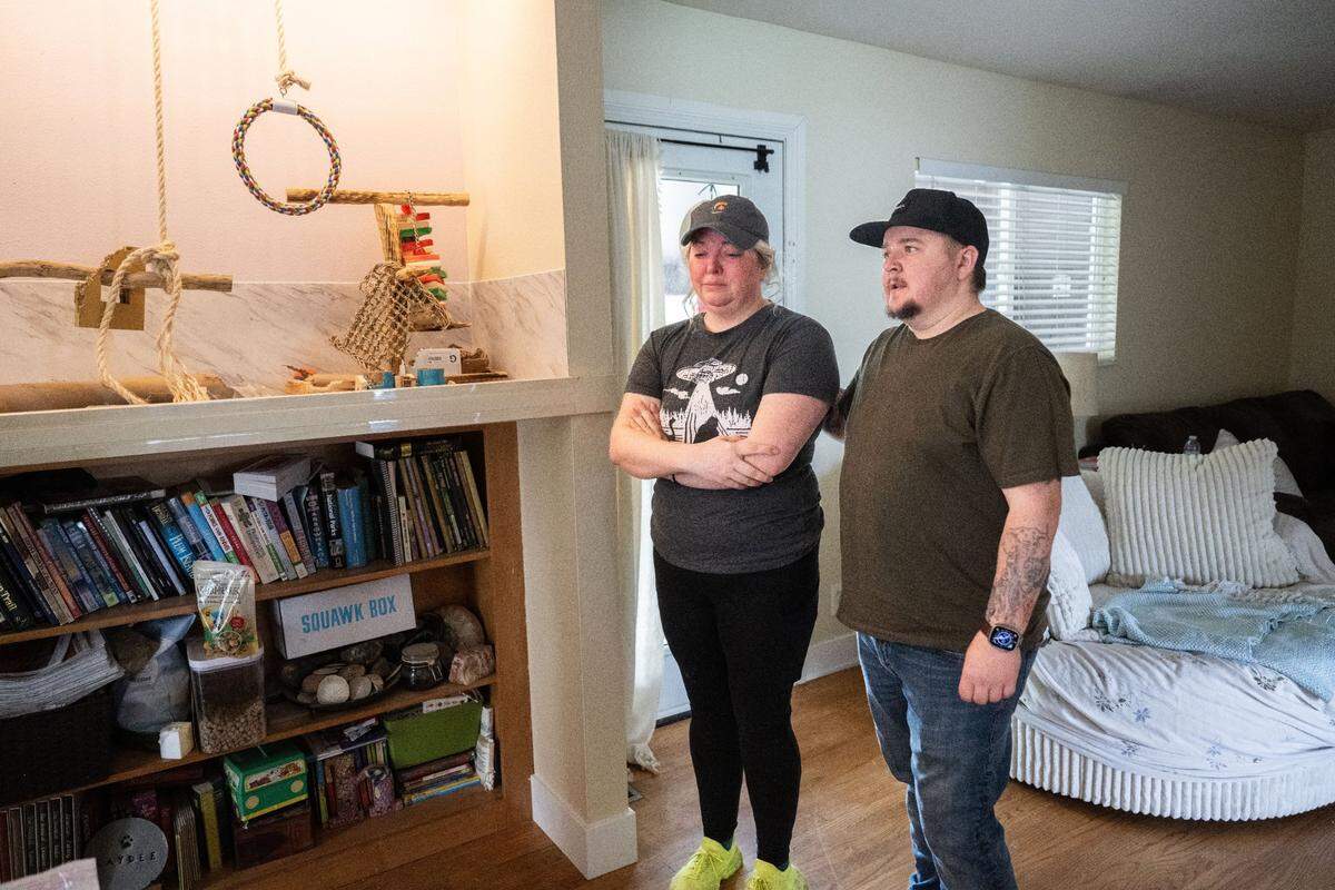 Holly Franklin, of Carmichael, is comforted on Friday by her friend Kyle Kaplanis, who has been helping look for her African grey parrot who went missing two weeks ago.