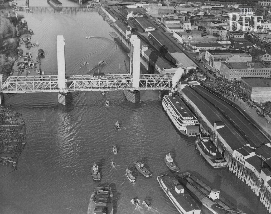A crowd gathers for the dedication ceremony for the Tower Bridge on Dec. 15, 1935, in an aerial image of the downtown Sacramento waterfront. The whistle of the Delta Queen, the large steamer docked to the right of the bridge, was bleating loudly during the festivities, according to news reports.