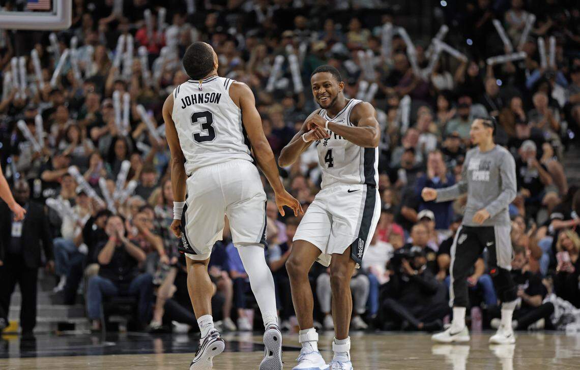 De'Aaron Fox (4) of the San Antonio Spurs celebrates with Keldon Johnson (3) after a dunk against the Sacramento Kings in second half at Frost Bank Center on Sunday, Nov. 16, 2025 in San Antonio, Texas.