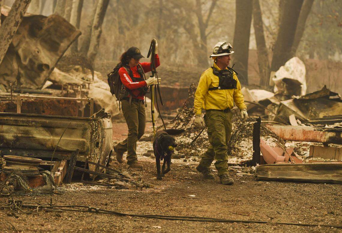 Butte County search and rescue workers in Paradise four days after the Camp Fire. The Paradise Irrigation District, financially ruined by the fire, now must fix Magalia Dam.