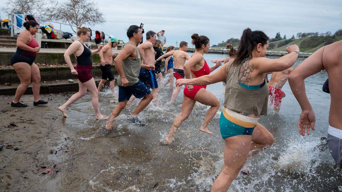 Despite the cold temperatures, an open water swimming group gathered Wednesday at Lake Natoma for a New Year’s Day polar bear plunge.