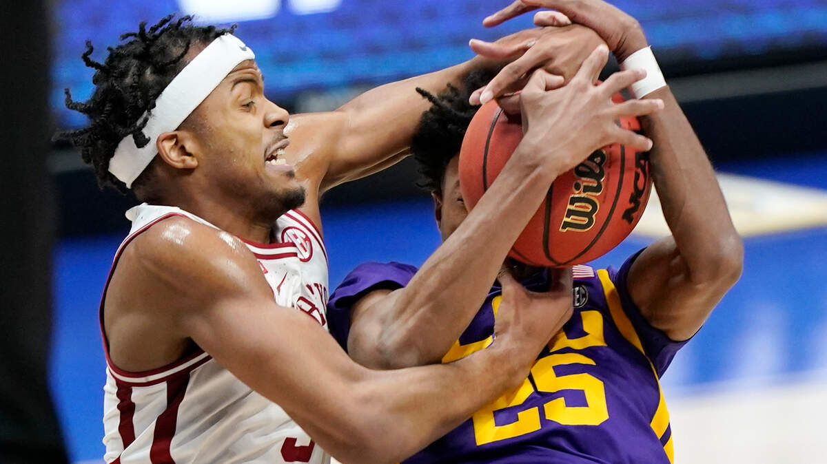 Arkansas’ Moses Moody, left, and LSU’s Eric Gaines (25) fight for a rebound in the first half of an NCAA college basketball game in the Southeastern Conference Tournament Saturday, March 13, 2021, in Nashville, Tenn. (AP Photo/Mark Humphrey)