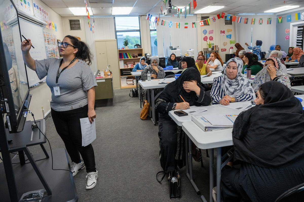 Mariam Mostajab teaches a zero-level English class for beginners at Highlands Community Charter and Technical School’s Grand Avenue campus in Sacramento last month. Many of the students are Afghan refugees who did not attend school in Afghanistan, according to the school’s principal.