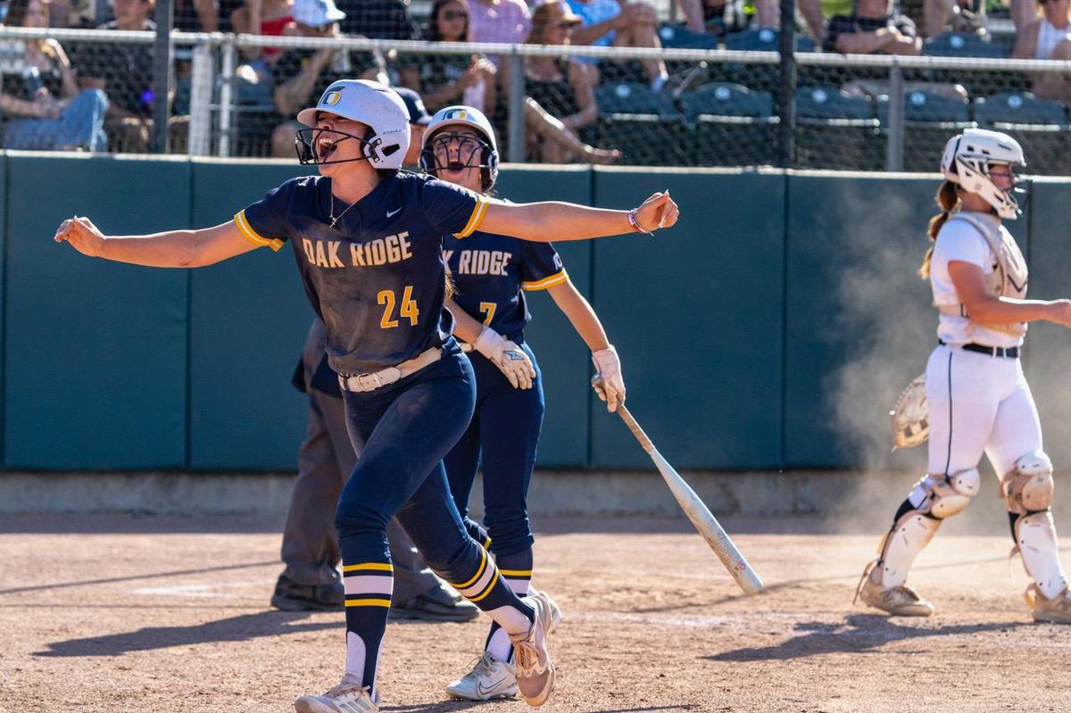 The Oak Ridge Trojans’ Carmen Montes de Oca celebrates scoring a run on a passed ball during the sixth inning of the CIF Sac-Joaquin Section Division I championship softball game Saturday between the Del Oro Eagles at Sacramento State.