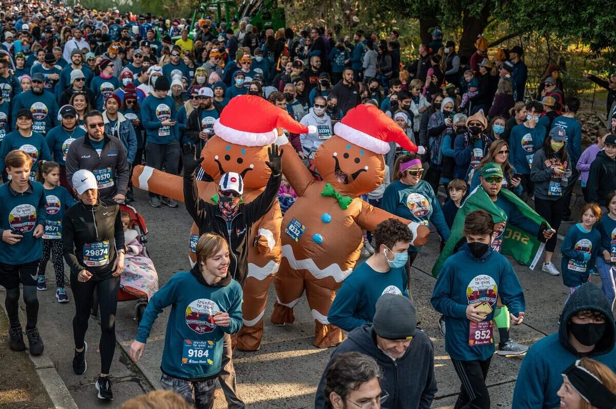 A pair of gingerbread people celebrate Thanksgiving Day at the 28th annual Run to Feed the Hungry on Thursday, Nov. 25, 2021.