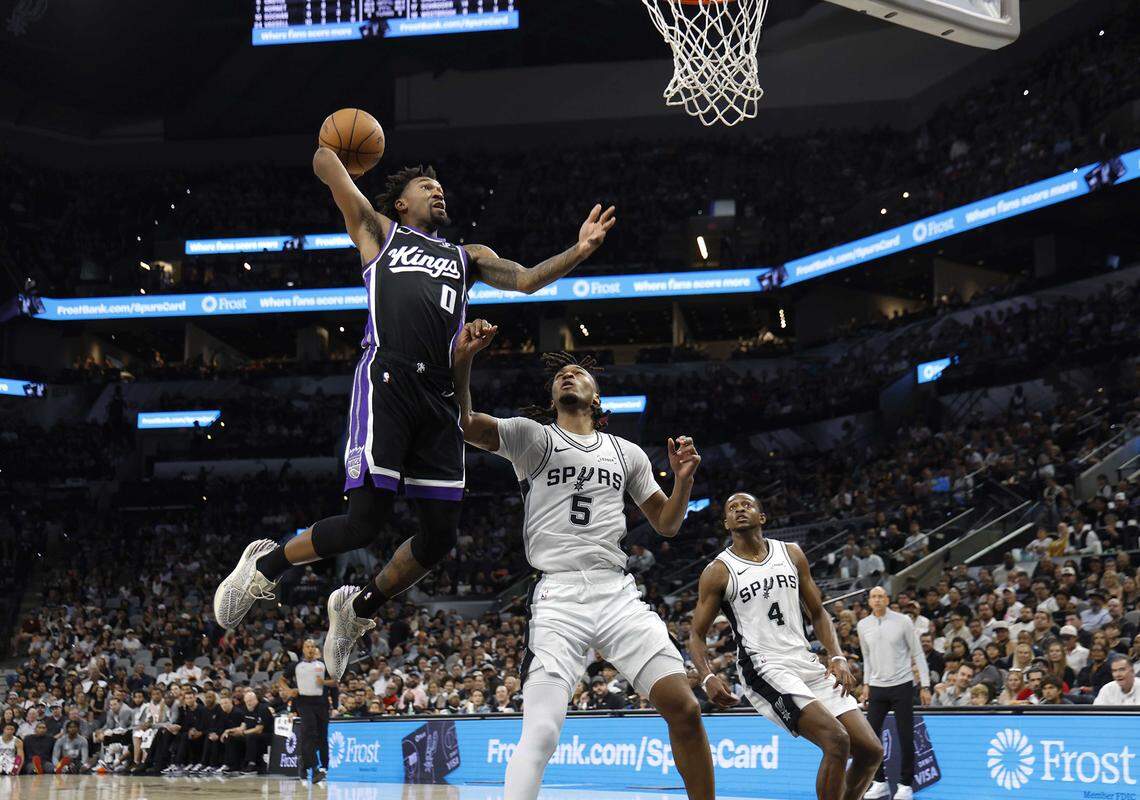 The Kings' Malik Monk dunks against the Spurs during the first half at Frost Bank Center on Sunday in San Antonio.