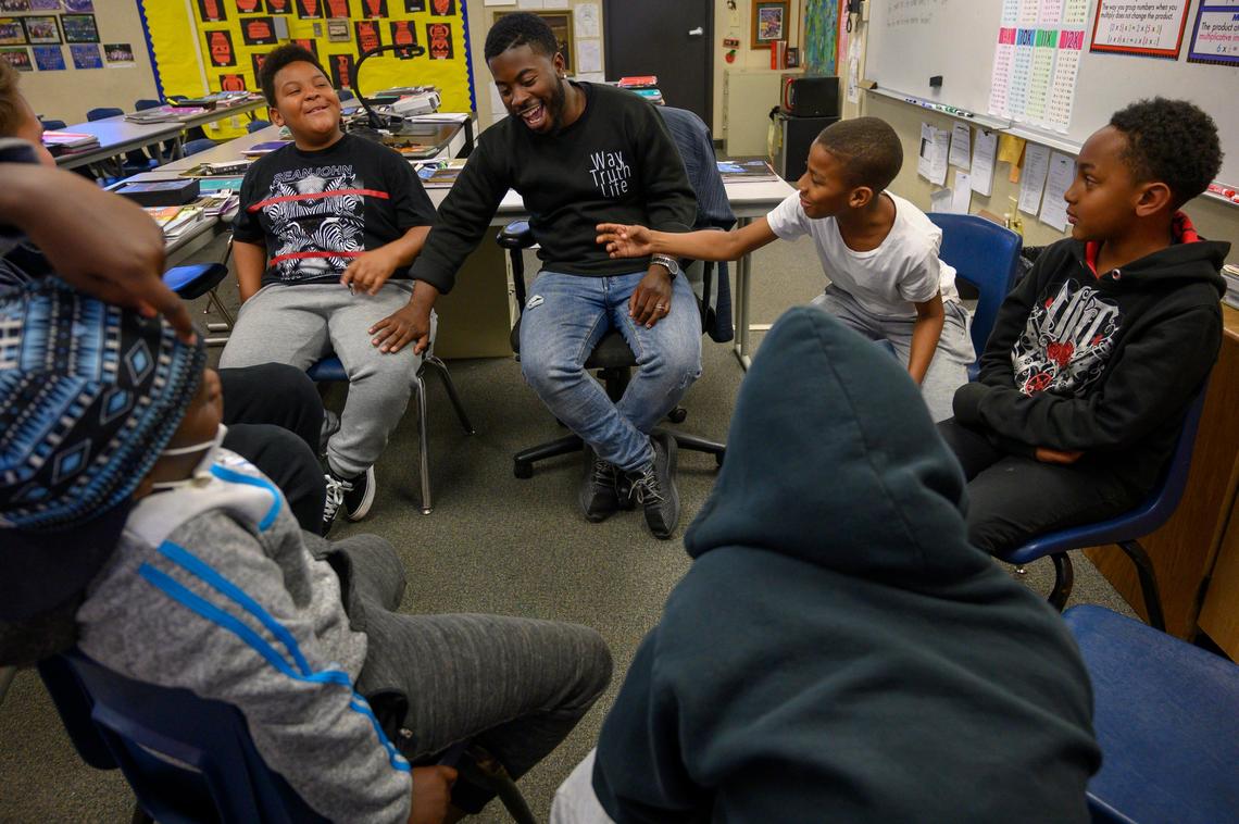 Tyler McClure with the Center for Fathers and Families shares a laugh with H.W.Harkness Elementary School children in an after school program in the Meadowview neighborhood on Friday, March 15, 2019 in Sacramento.