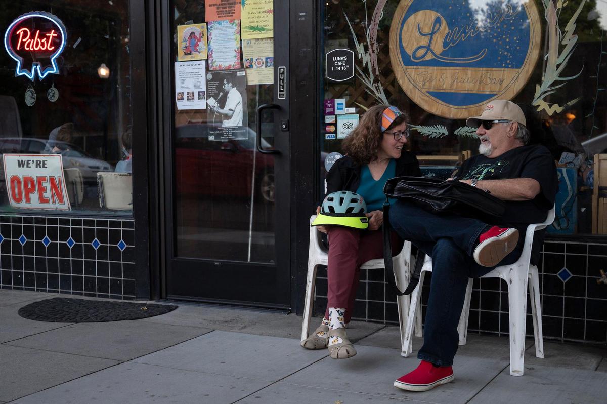 Suzan Tobin, left, of Sacramento, talks with Dave Bass outside of Luna’s Cafe on Monday. Luna’s will close at the beginning of August after 40 years of business.