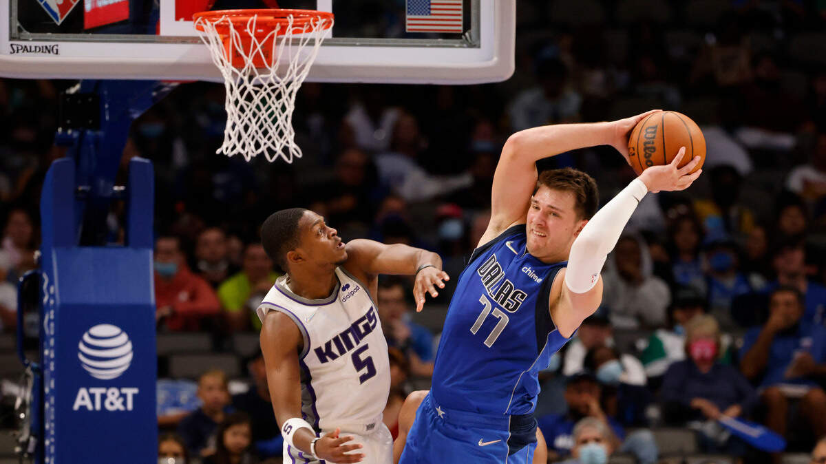 Sacramento Kings guard De’Aaron Fox (5) defends against Dallas Mavericks guard Luka Doncic (77) during the second half of an NBA basketball game in Dallas, Sunday, Oct. 31, 2021. (AP Photo/Michael Ainsworth)