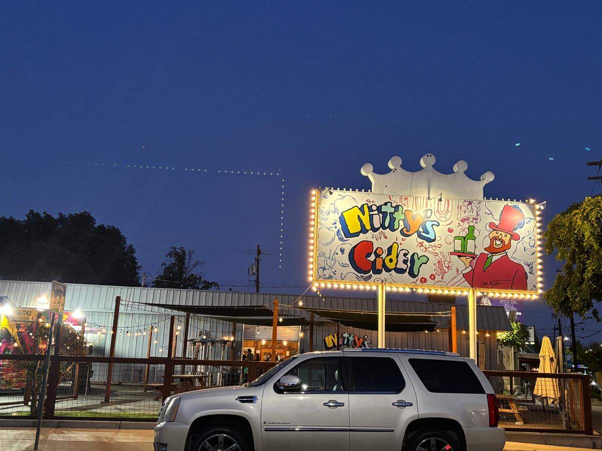 The Nitty’s Cider sign is lit up over the Folsom Boulevard and 32nd Street tasting room in East Sacramento on Thursday, April 17, 2025.