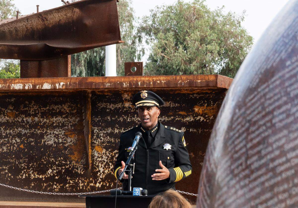 As the granite sphere inscribed with the names of 3,071 victims of the terrorist attack rotates at right, Sacramento County Sheriff Jim Cooper stands in front of a steel girder from the World Trade Center as he speaks to honor first responders and U.S. troops during the 9/11 Remembrance Ceremony at September 11 Memorial Plaza at Cal Expo in Sacramento on Thursday.
