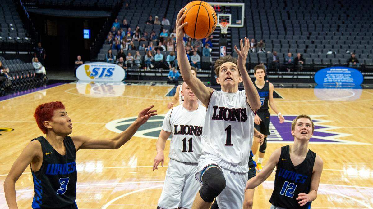 The Valley Christian Lions’ Ian Gaspy drives to the basket against the Sacramento Waldorf Waves’ Zihao Chen during the CIF Sac-Joaquin Section Division VI high school boys basketball championship game Friday.