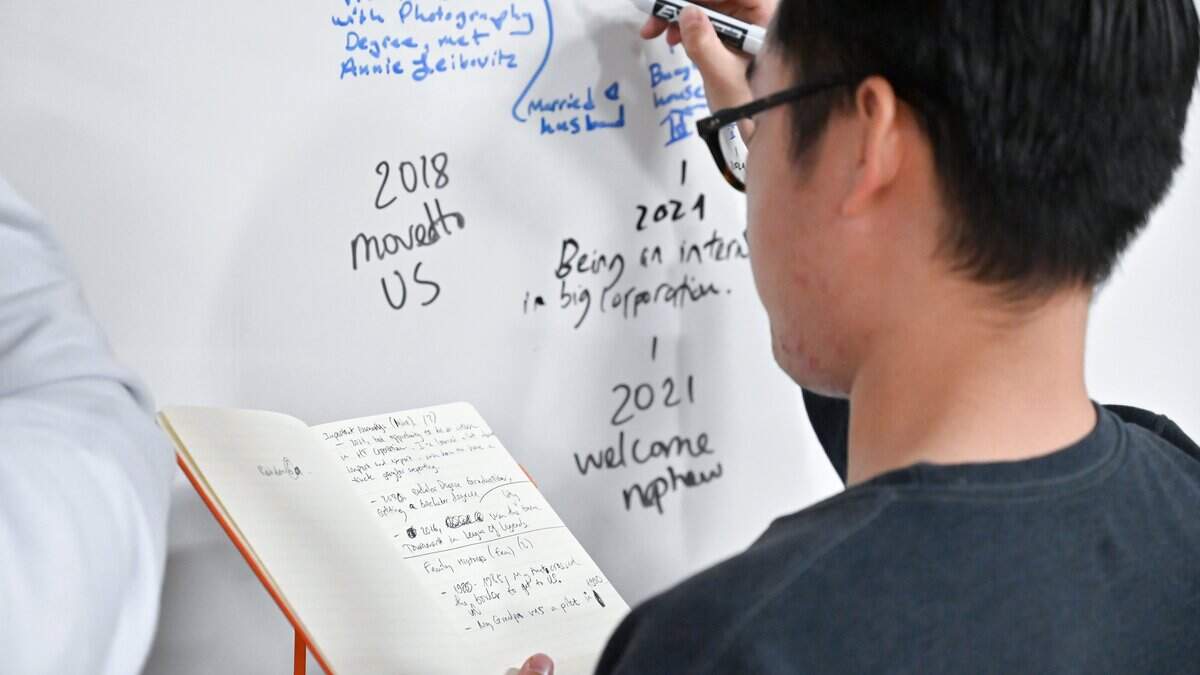 A student writes on the whiteboard in a classroom at Sacramento City College on Wednesday, Dec. 6, 2023. Several part-time faculty members are suing community college districts across California over alleged failure to pay them for outside-the-classroom work.