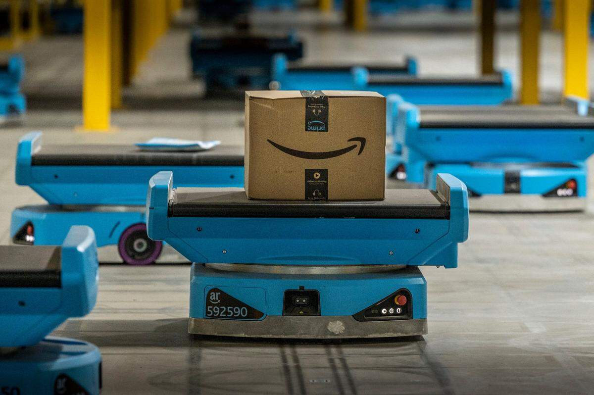 A robot carries a package at the Amazon fulfillment center in Tracy on Friday. While the robots are efficient and help lighten the load on workers, some dropped packages still have to be recovered by specially trained workers.