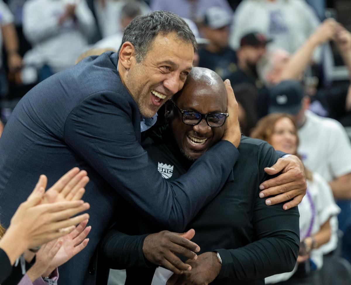 Former Sacramento Kings player and general manager Vlade Divac hugs former Kings player Bobby Jackson, who now coaches the Stockton Kings, during Game 1 of the first-round NBA playoff series at Golden 1 Center on Saturday, April 15, 2023.
