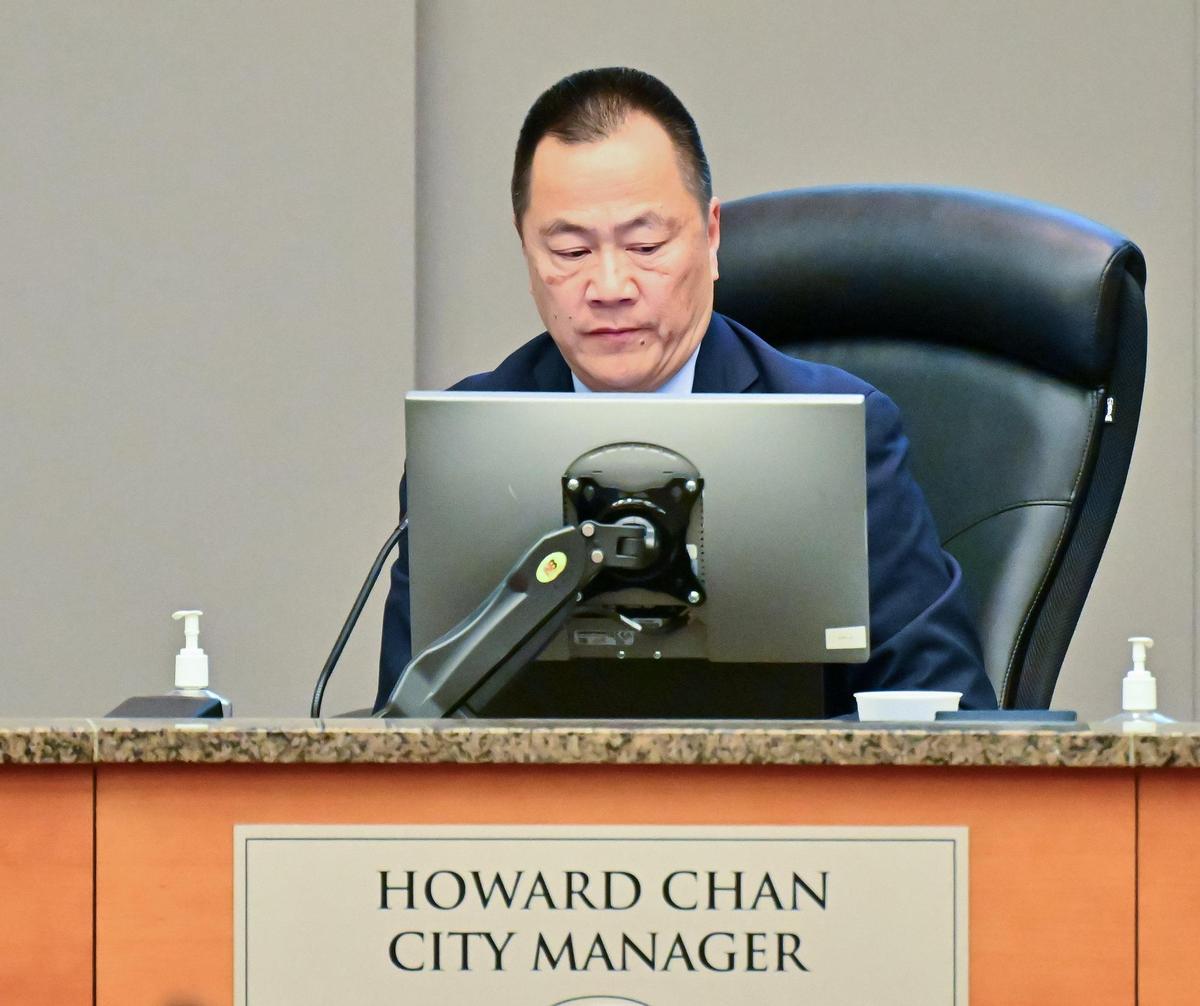 Sacramento City Manager Howard Chan packs his belongings after the vote on his proposed raise was delayed Tuesday until a future council meeting.