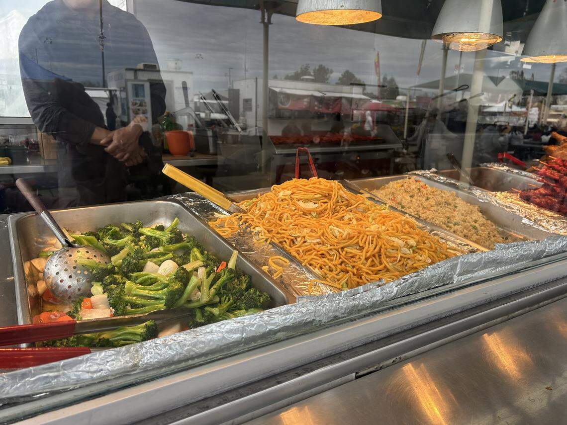 A food truck sells Chinese food at the Galt Flea Market. Piles of lo mein, rice and vegetables wait for hungry customers.