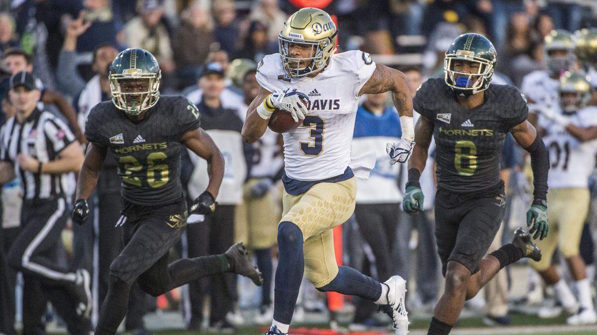 Keelan Doss, center, and UC Davis will no longer host the 65th Causeway Classic at Aggie Stadium. The annual rivalry game with Sacramento State will be played Saturday in Reno.