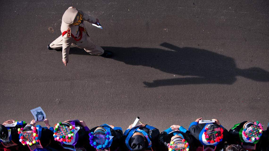 Hmong women in traditional attire line a Fresno street to watch a funeral procession of the late General Vang Pao in 2011. Women in the Sacramento area are speaking out about the Hmong clan system following comments by Elk Grove Mayor Steve Ly.