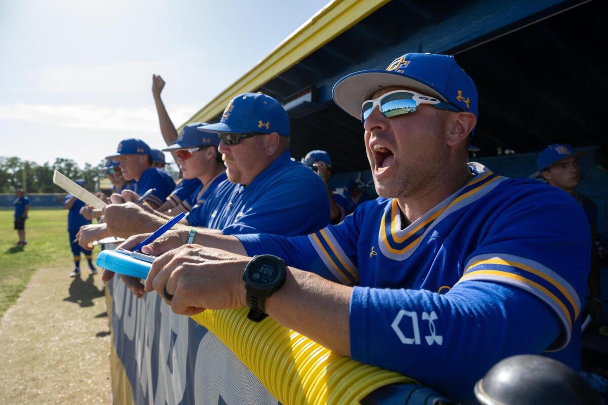 Del Campo Cougars head coach Kevin Dawidczik speaks with players during a first-round Sac-Joaquin Section Division IV baseball playoff game on Wednesday in Fair Oaks.