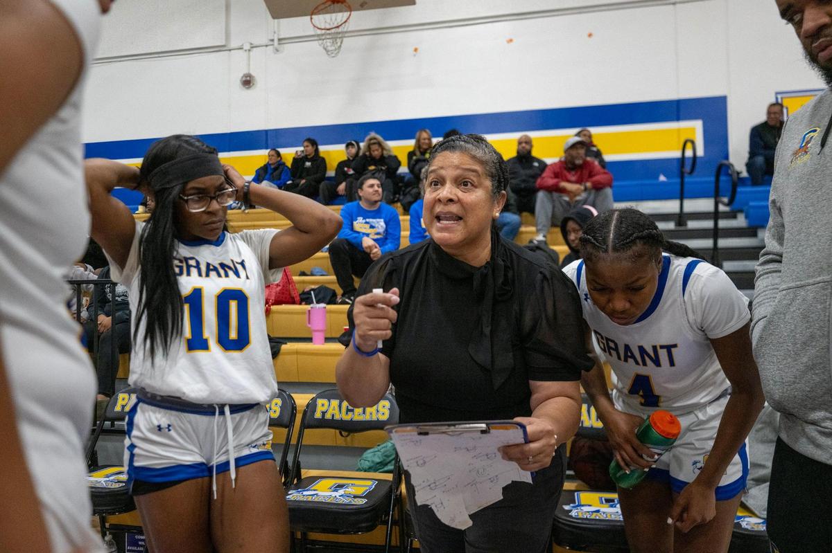 Grant Pacers coach Michelle McCauley speaks to her team before the start of the game against the Kennedy Cougars on Friday in Del Paso Heights.