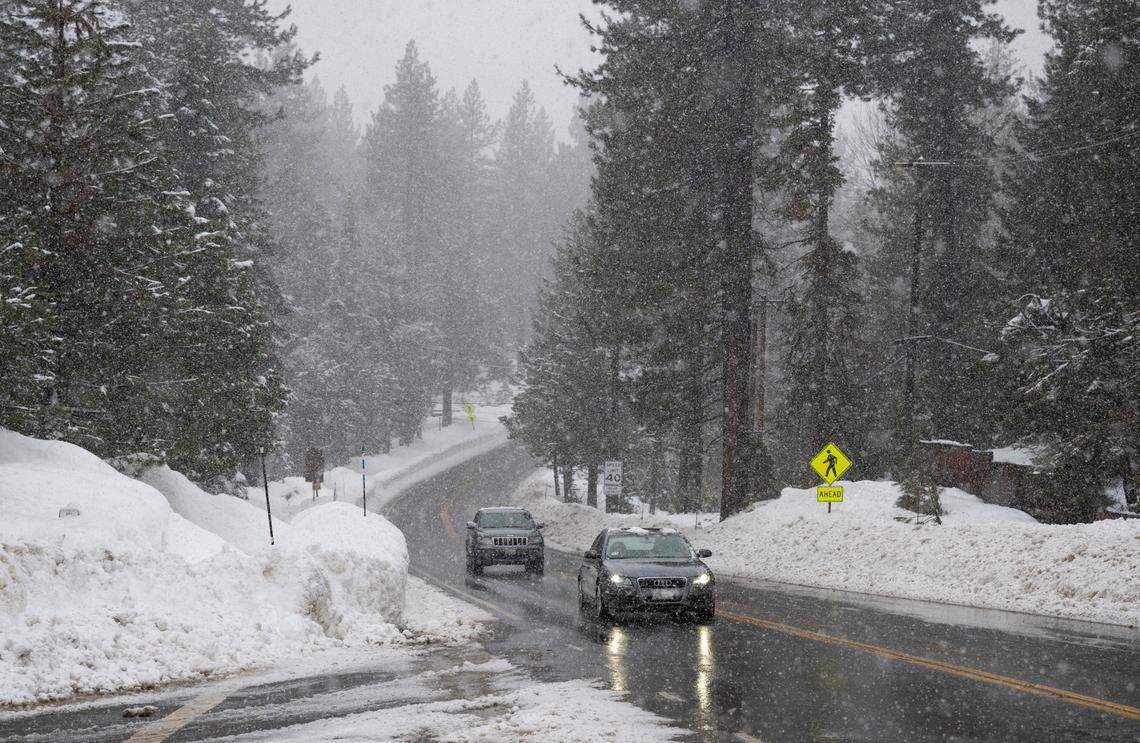 Vehicles move swiftly as snow falls on Highway 89 along the west shore of Lake Tahoe on Thursday, Jan. 5, 2022.