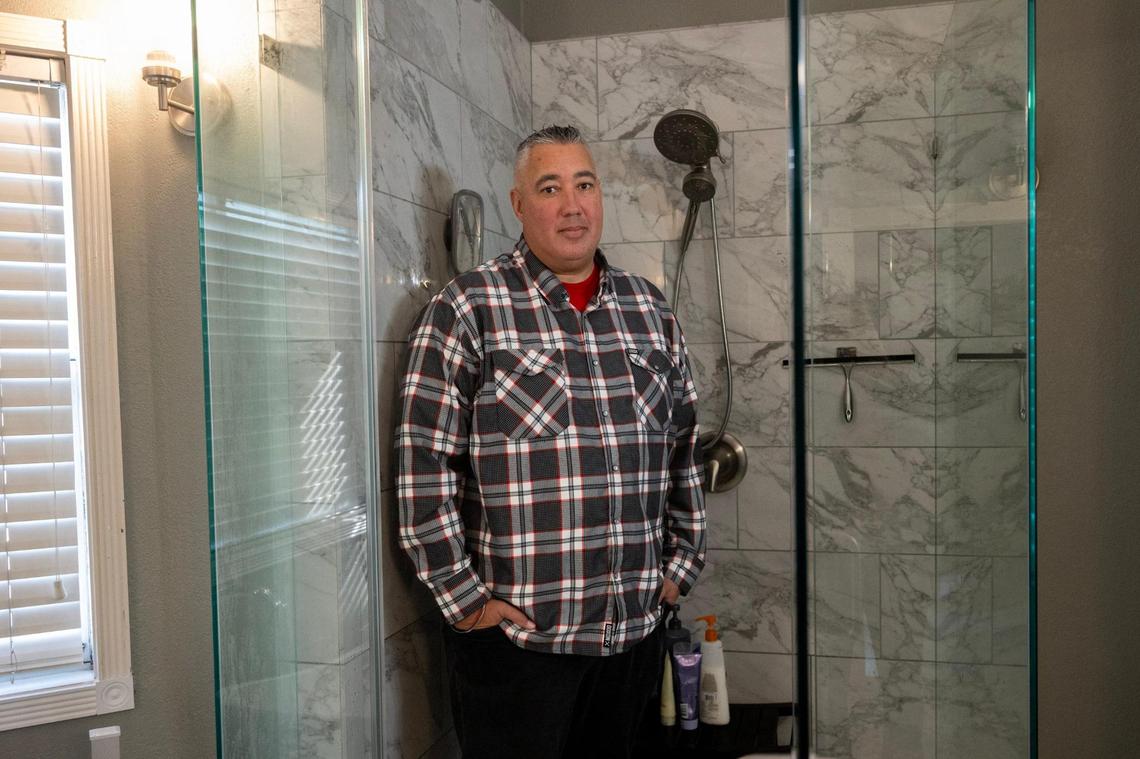 Homeowner Jeff Garcia stands in the master bath shower of his Folsom home in December. In 2022, a leak in the bathroom caused a large water bubble to appear in the downstairs ceiling. Garcia believed he would be covered but State Farm denied the claim, saying it was the result of a “continuous and/or repeated seepage or leakage of water over time” and not a sudden event.