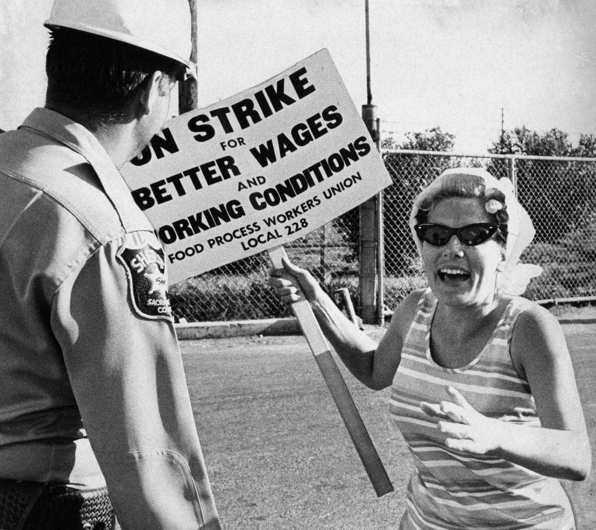This unidentifed woman confronted by Sacramento Sheriff’s deputies on Aug. 14, 1968, as she tried to stop a truck of tomatoes from entering the Campbell’s Soup plant on the second day of a strike by members of Food Process Workers Union Local 288. A later photo shows her being forcibly taken into custody.