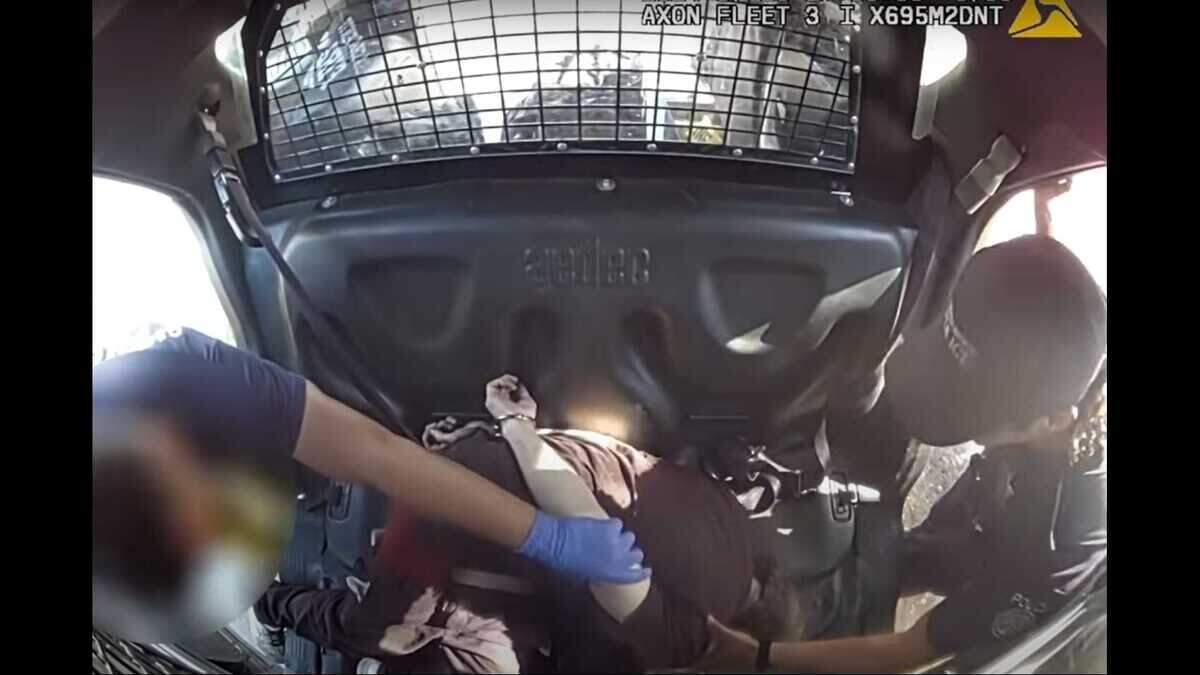 A Sacramento Fire Department firefighter and a Sacramento police officer attempt to speak with James Dehart on July 23, who is unresponsive to their questions. Dehart was detained by police after he barricaded himself inside a vehicle. Dehart was later pronounced dead at a hospital and police are investigating his death as an “in-custody” death.